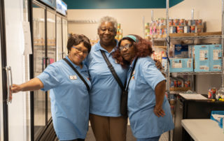 three african american woman posing for a picture in the Food Pantries at Senior Communities
